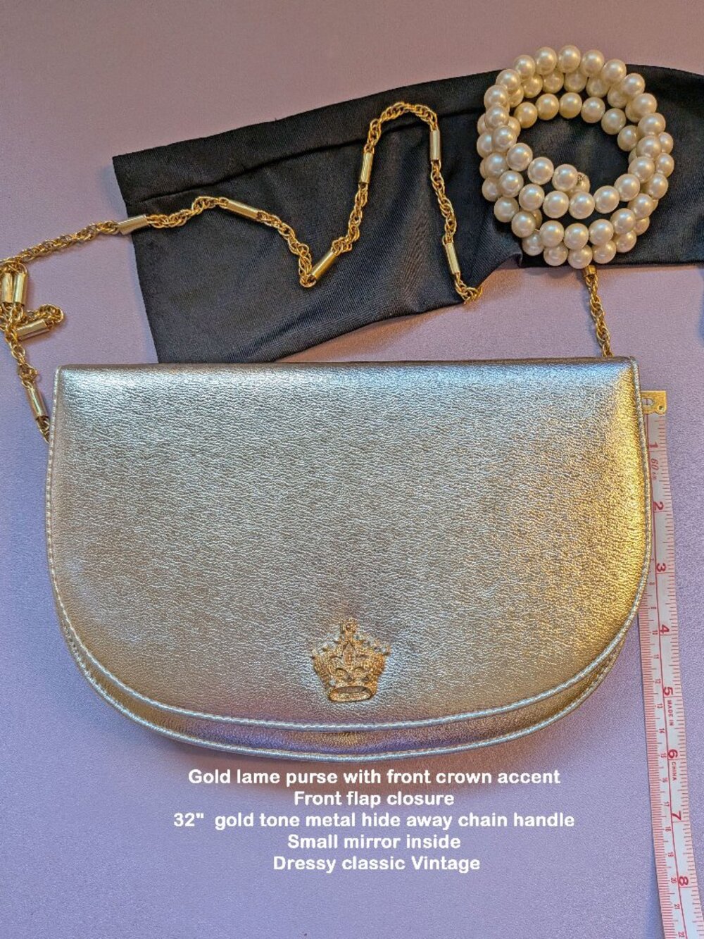 Gold lame purse. Front crown trim, Front flap closure, 32" gold tone metal chain